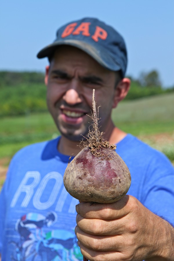Nuno Reis showing off beets at the Farm. 