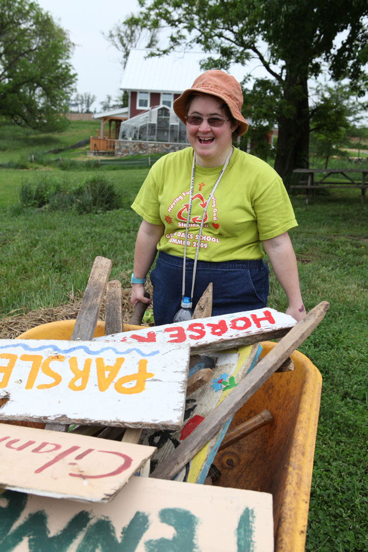Grower, Elaine, transporting signs on the Farm. 